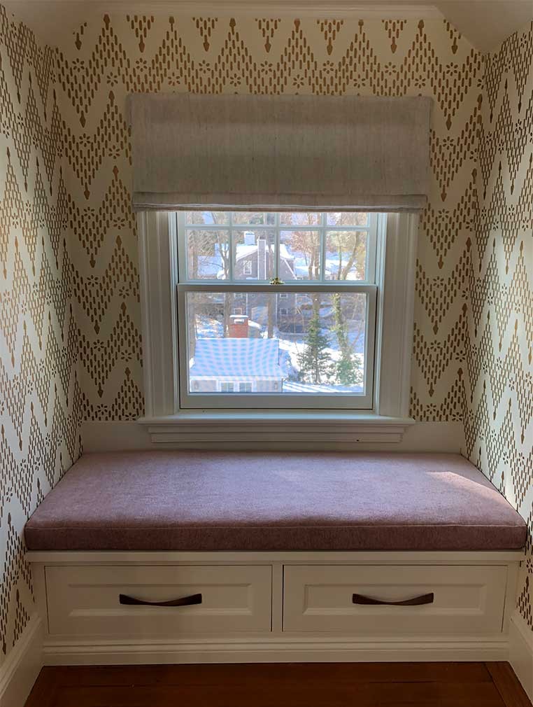 A window seat with drawers underneath